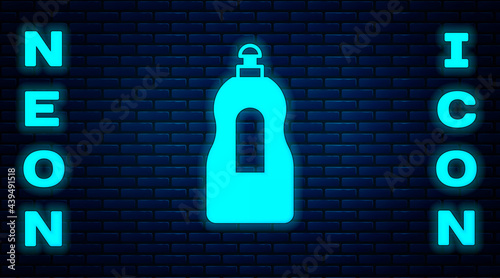 Glowing neon Dishwashing liquid bottle icon isolated on brick wall background. Liquid detergent for washing dishes. Vector
