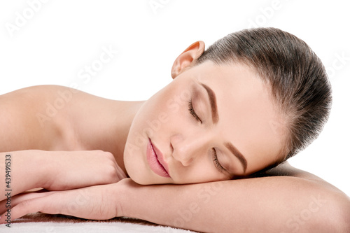 relaxed young woman with closed eyes after spa procedures