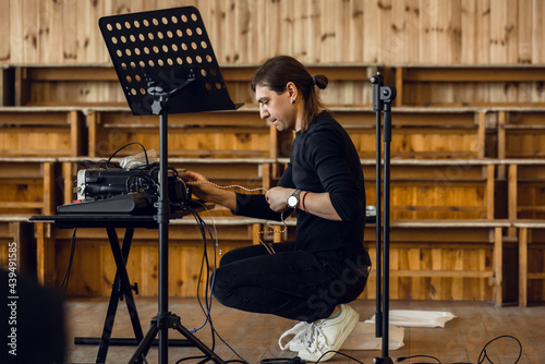 musician sound engineer setting up sound equipment