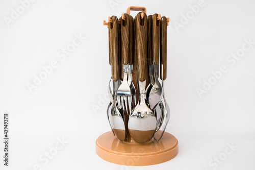 Spoon and fork with wooden handles on the white background