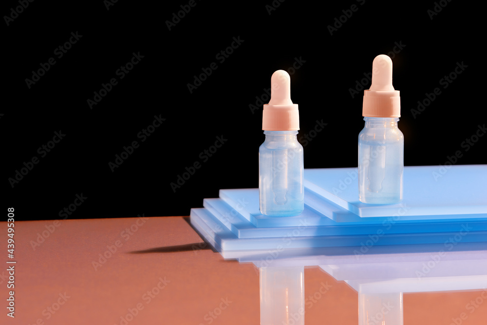 Glass dropper bottles with a pipette with rubber tip on the beautiful shadow Glass dropper bottles with a pipette with rubber tip on the beautiful shadow