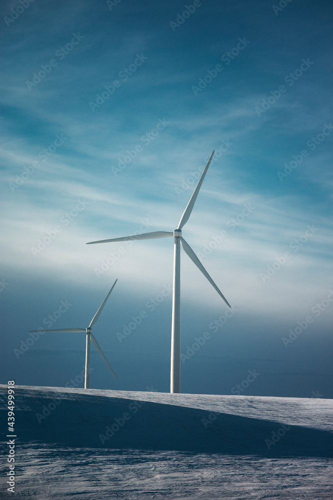 Windmills on the prairies during winter. Windmills on the prairies during winter.