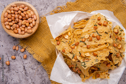 Rempeyek or peyek kacang is a deep-fried savoury Indonesian-Javanese cracker made from flour (usually rice flour) with peanut, lime leaves and other ingredients, bound or coated by crispy flour batter