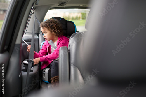 Girl in high back booster seat photo