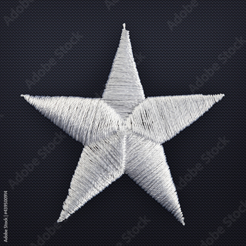 Macro shot of hand stitched gray star from an american flag.