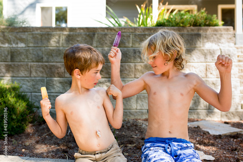 Boys with popsicles flex to show off muscles photo