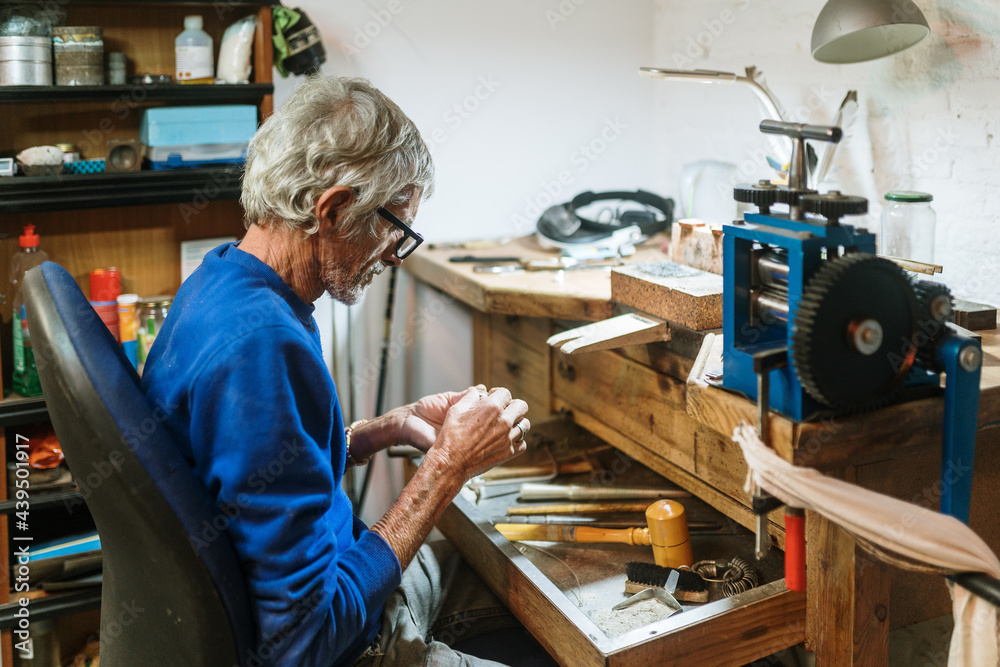 Old jeweler working on a ring Old jeweler working on a ring