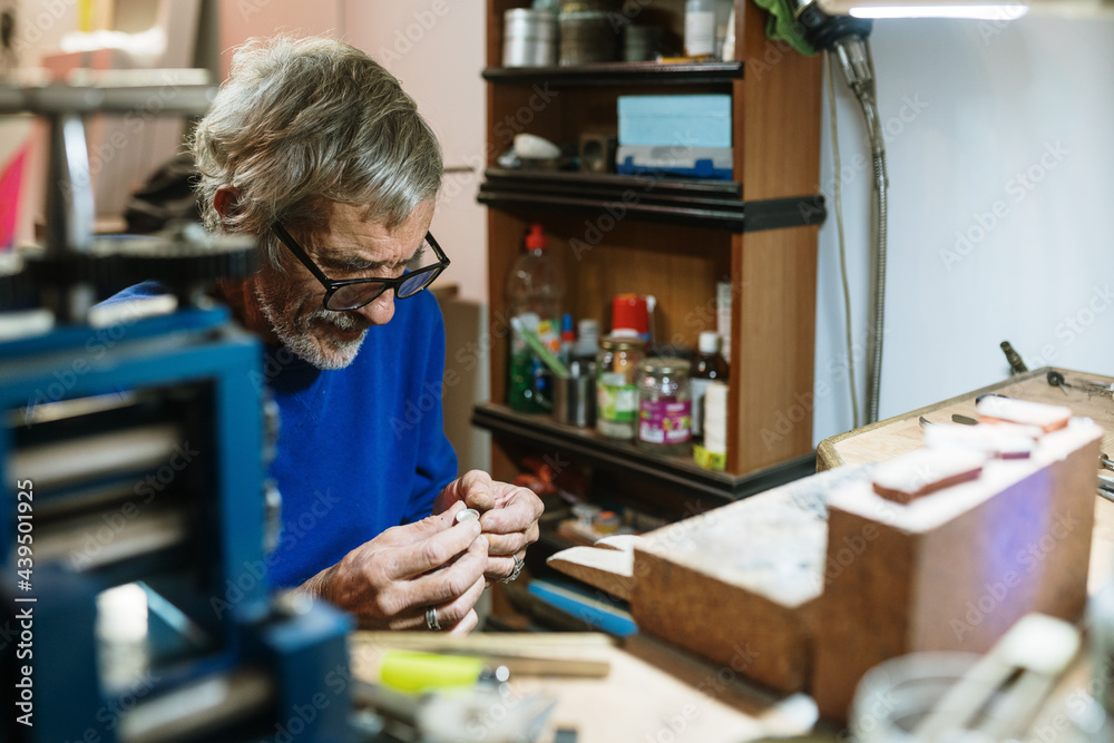 Old jeweler working on a ring Old jeweler working on a ring