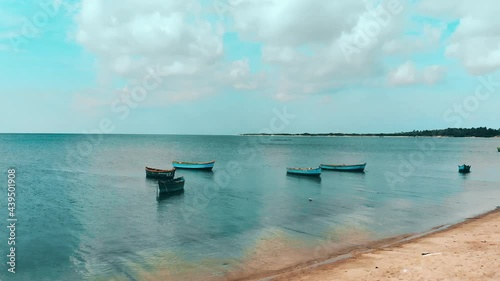 boats on the sea in front of the beach
