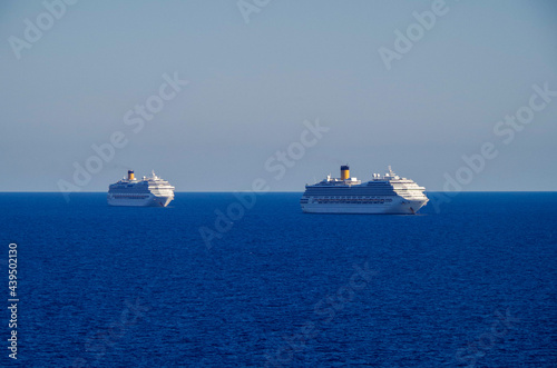 Costa cruiseships or cruise ship liners Pacifica, Fortuna and Favolosa anchored at sea offshore of Civitavecchia, Rome in Italy on sunny summer day with blue sky due to Corona Pandemic Pause photo