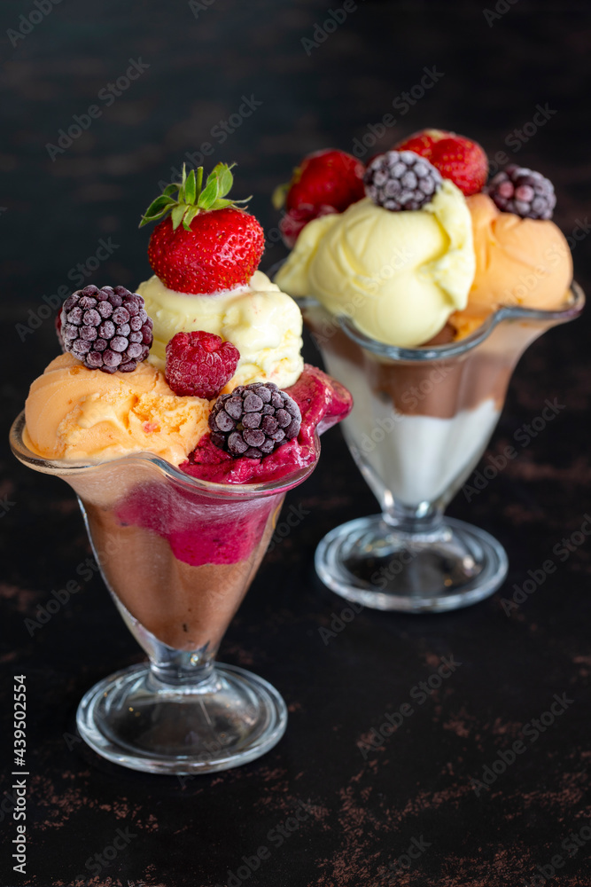 Ice cream in glass bowl. Ice creams on dark background. Milk, chocolate, cherry, melon and caramel ice cream. Ice cream in glass bowl. Ice creams on dark background. Milk, chocolate, cherry, melon and caramel ice cream.