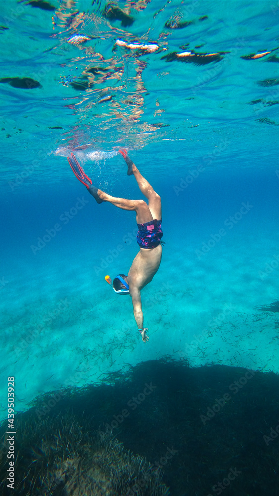 underwater man snorkeling in the sea withcrystal-clear waters concept of holiday relax summer beach diver in the sea