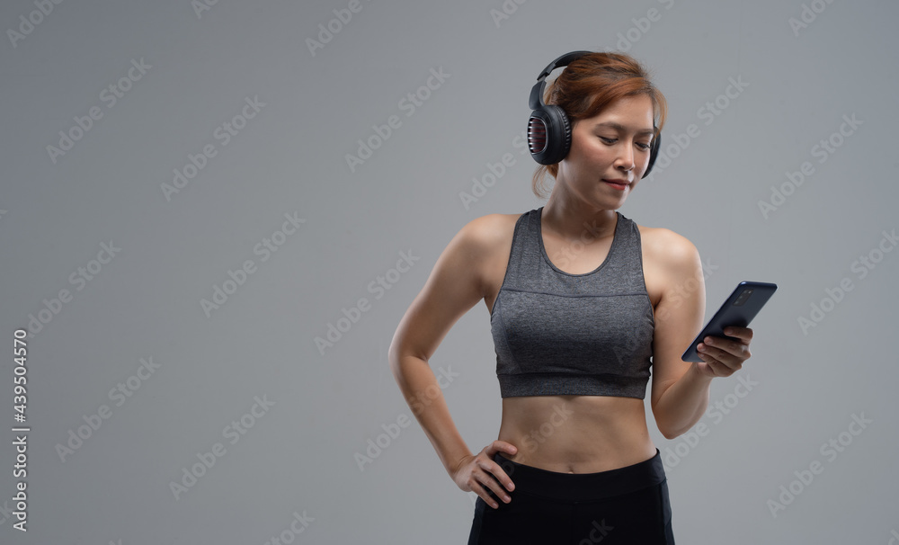 Woman resting after home workout with mobile phone, free space Woman resting after home workout with mobile phone, free space