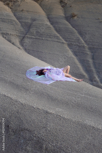 Woman standing in nature with purple dress photo