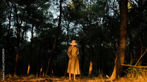 woman with wearing a trench coat in the forest photo