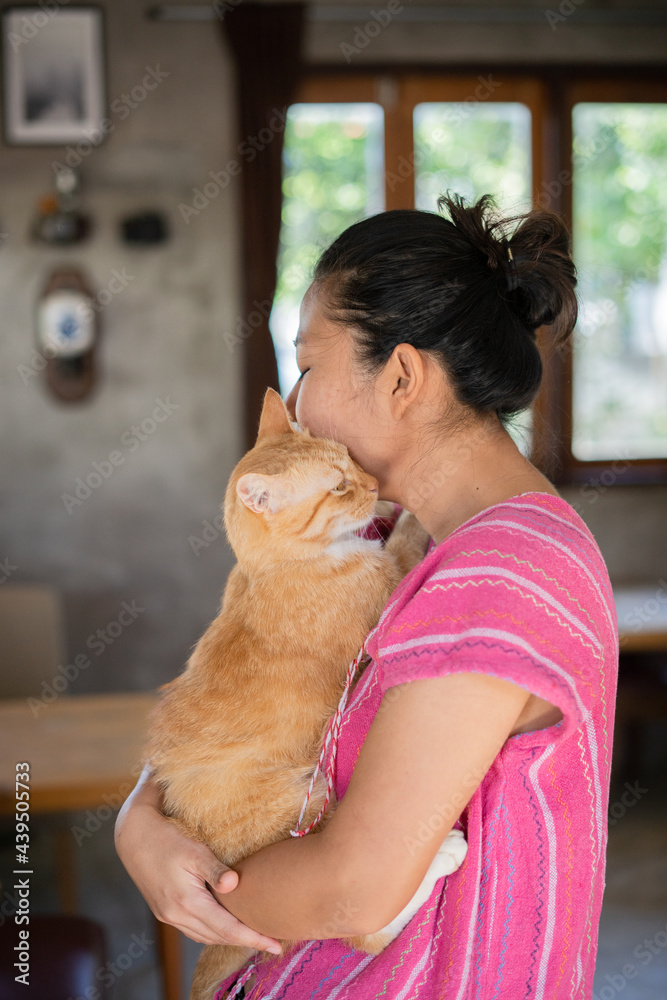 Asian woman holding cat