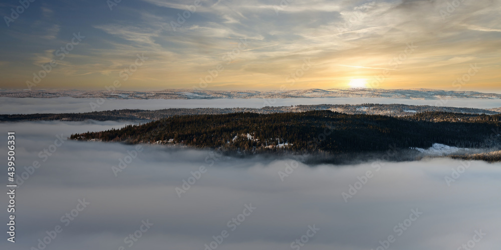 sunset over the fog. The fog is thick in Oslo, Norway. But above the fog layer is a beautiful sunset. sunset over the fog. The fog is thick in Oslo, Norway. But above the fog layer is a beautiful sunset.