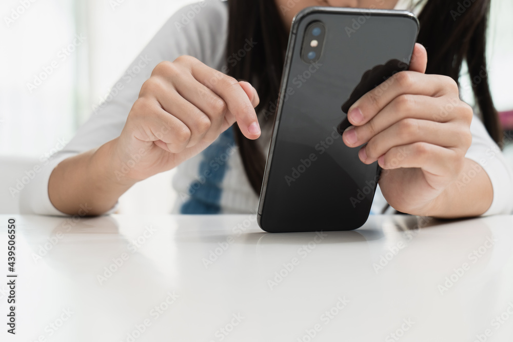 Close up image of an asian little girl using a smartphone. Close up image of an asian little girl using a smartphone.