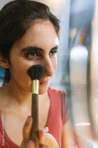 woman applying makeup photo