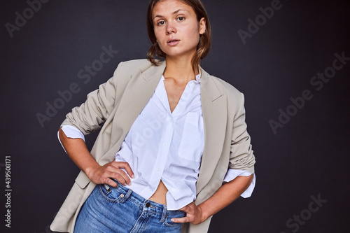 Stylish young woman in jeans and a blazer