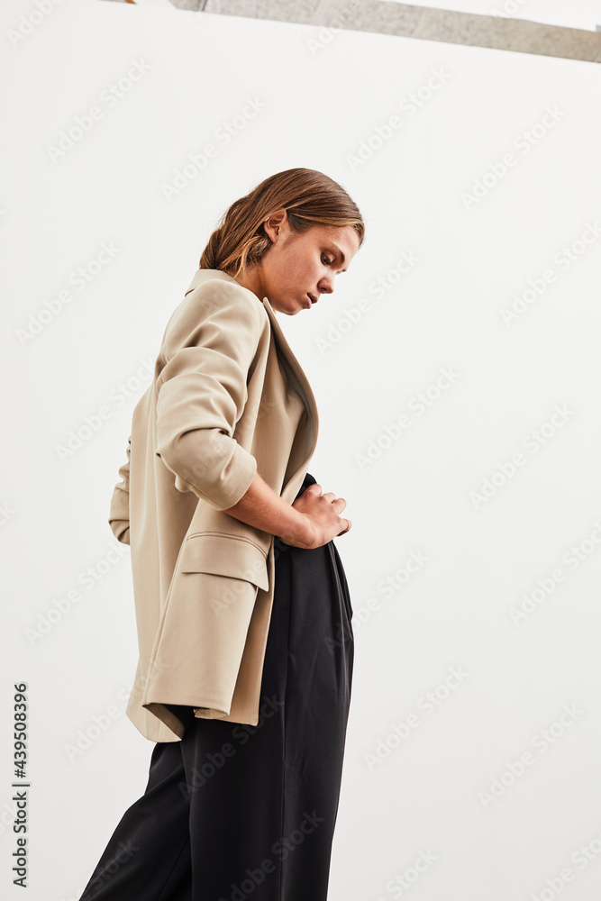 Young woman standing against a white backdrop Young woman standing against a white backdrop