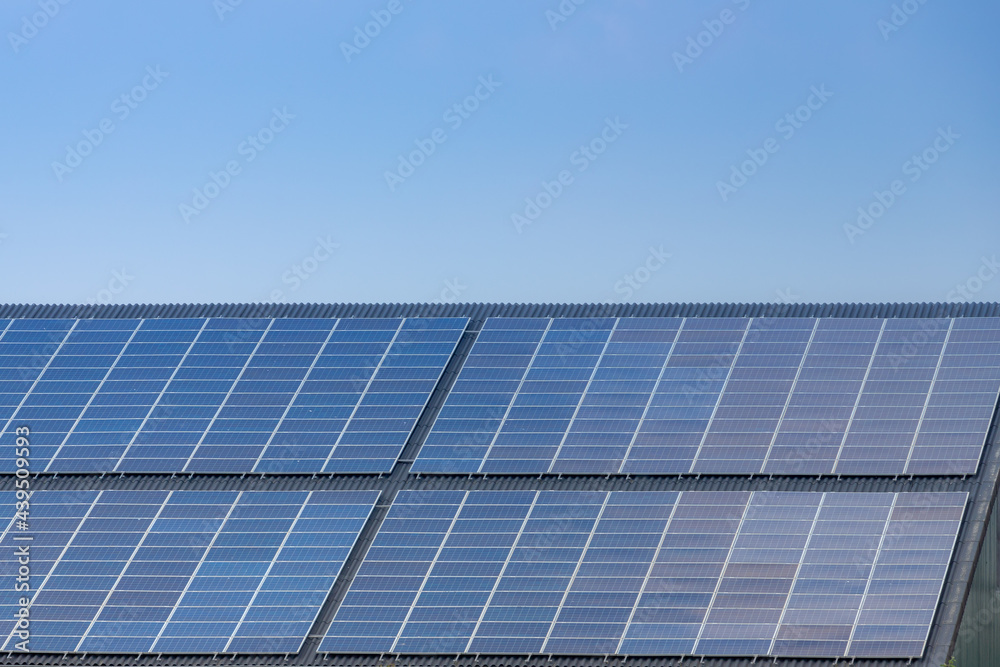 Green energy concept, A solar cell panel on the rooftop under blue sky, Photovoltaic cell is an electrical device that converts the energy of light directly into electricity by the photovoltaic effect Green energy concept, A solar cell panel on the rooftop under blue sky, Photovoltaic cell is an electrical device that converts the energy of light directly into electricity by the photovoltaic effect