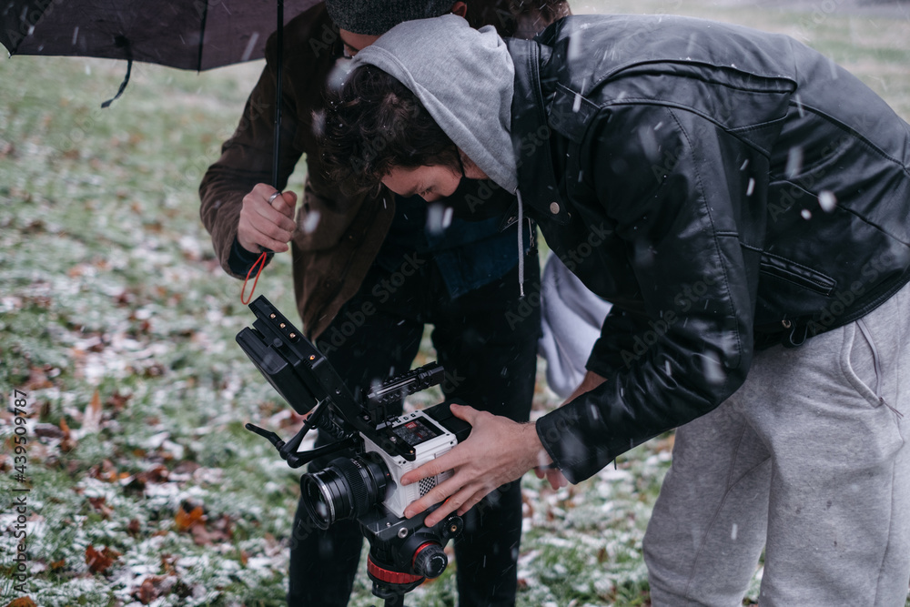 Camera operator and director filming in a field Camera operator and director filming in a field