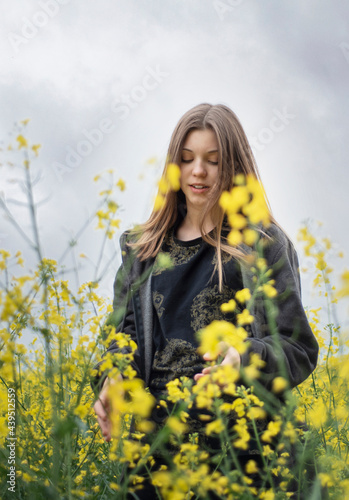 Young girl on yellow rapeseed field
