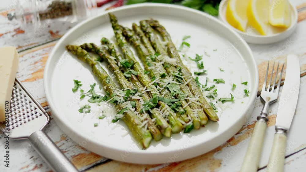 Roasted asparagus with parmesan cheese and parsley. Healthy spring food concept. View from above. Roasted asparagus with parmesan cheese and parsley. Healthy spring food concept. View from above.