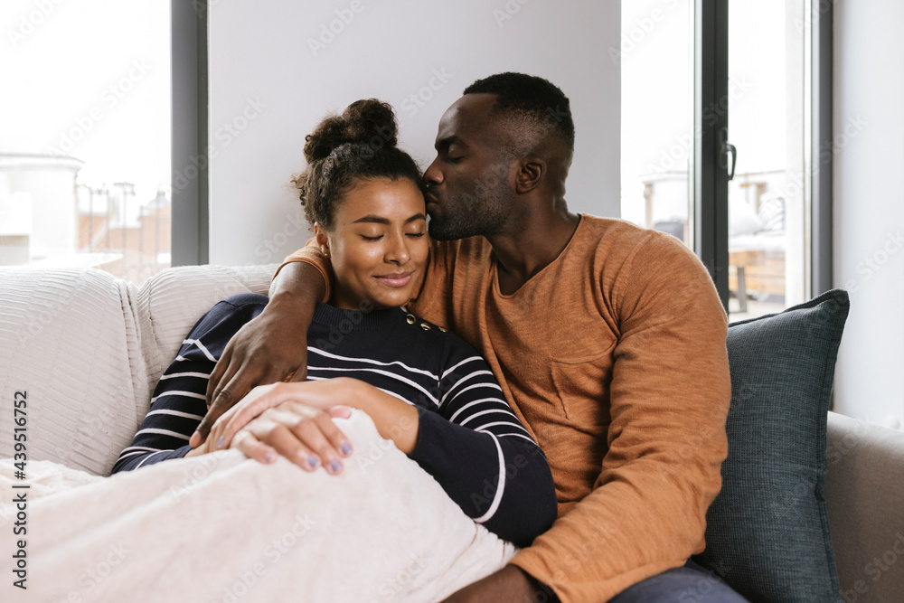 Tender black couple hugging with closed eyes Tender black couple hugging with closed eyes