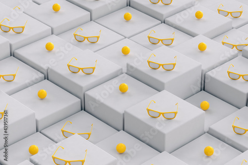 Yellow sunglasses on grey, randomly positioned cubes photo