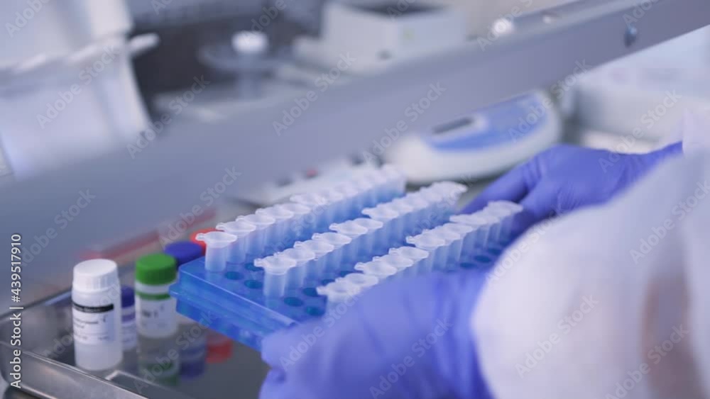 Hands of a laboratory assistant in medical gloves, works with Covid-19 analyzes in test tubes in a fume hood. Close-up side view and slider camera zoom. FullHD Slow Motion Hands of a laboratory assistant in medical gloves, works with Covid-19 analyzes in test tubes in a fume hood. Close-up side view and slider camera zoom. FullHD Slow Motion