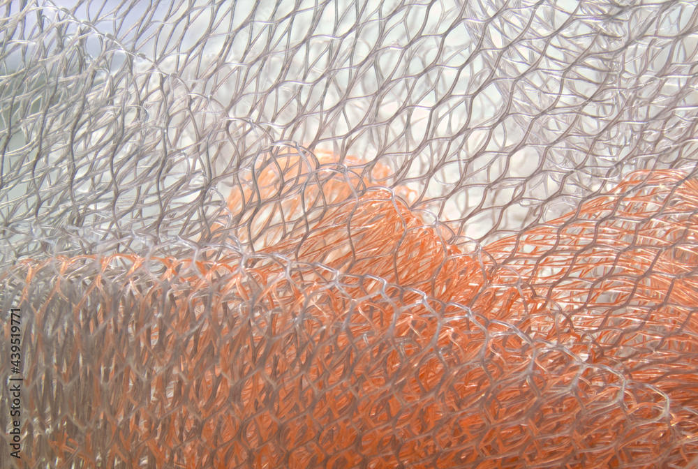 macro of orange and white mesh fabric patterns