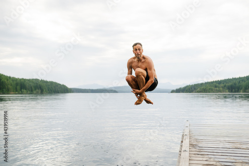 Man cannon ball into lake photo