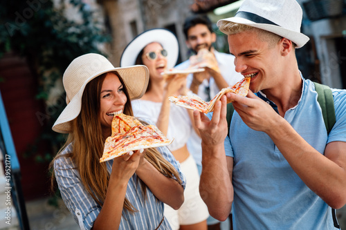 Friends having fun and eating pizza. Dating,consumerism, food and lifestyle concept.