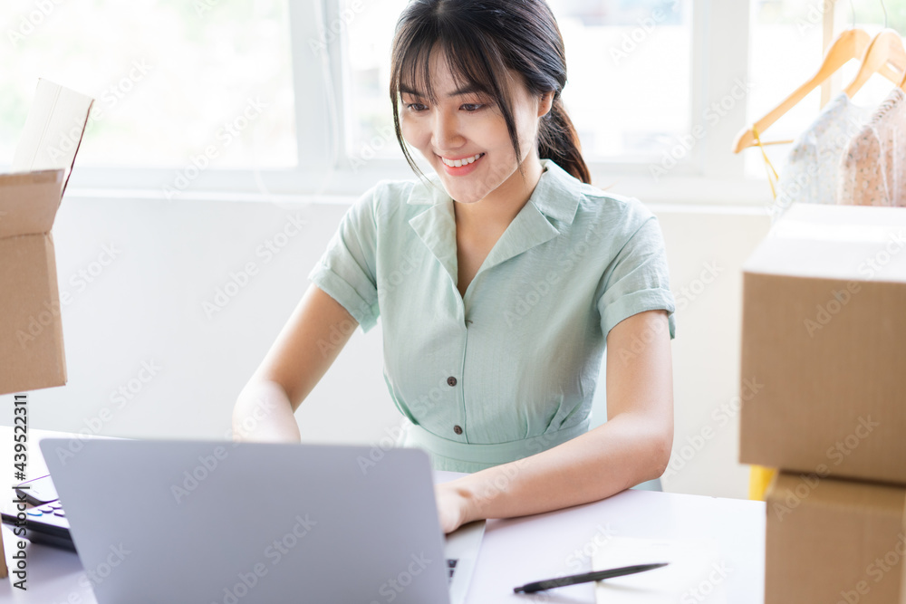 Young Asian woman starting a home-based online sales career Young Asian woman starting a home-based online sales career