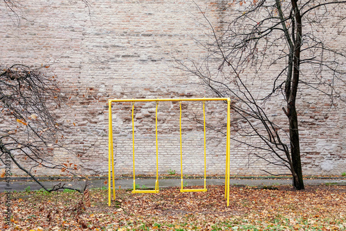 Old abandoned swing set in empty yard