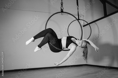 Athletic Woman Posing on Lyra Hoop photo