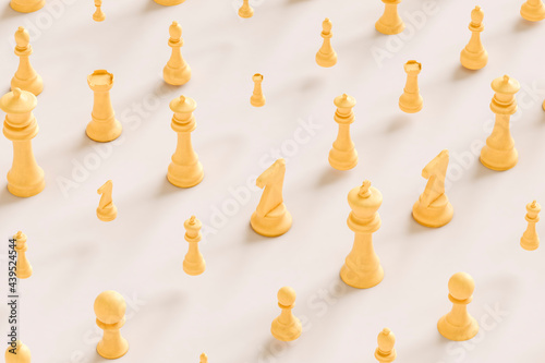 chess pieces in yellow on grey background photo