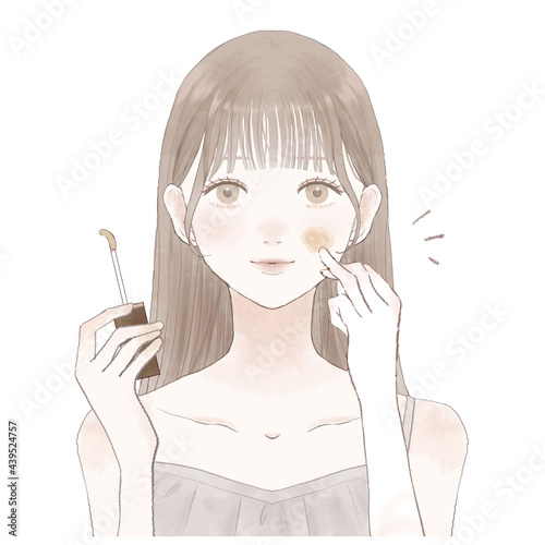 コンシーラーを顔に塗っている女性