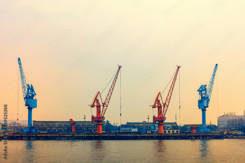Cranes in blue and orange at an industrial port