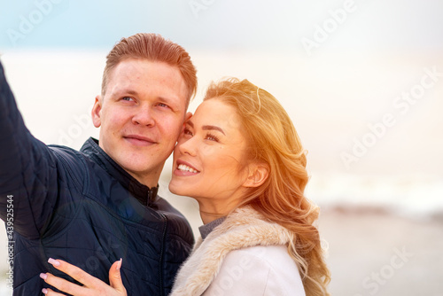 Happy romantic Smiling couple taking selfie on the sunny beach