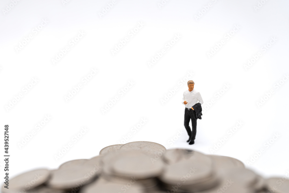 Business, Money Investment and Planning Concept. Businessman miniature figure people figure walking to pile of silver coins on white background. Business, Money Investment and Planning Concept. Businessman miniature figure people figure walking to pile of silver coins on white background.
