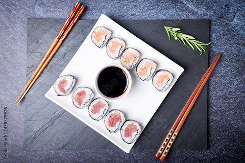 Top view of a plate with sushi and its wooden chopsticks. Asian food. Healthy food concept