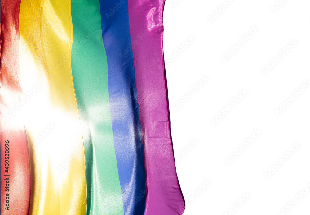 Rainbow flag in sunshine on white isolated