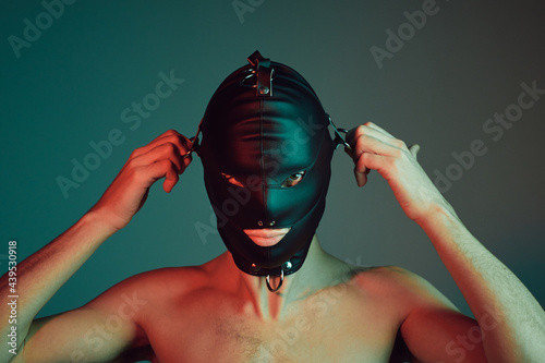 Male slave wearing a fetish mask.
