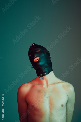 Young male wearing a gimp mask.
 photo