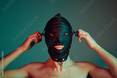 Male slave wearing a fetish mask. photo