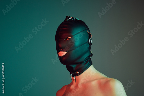 Young male wearing a gimp mask.
 photo
