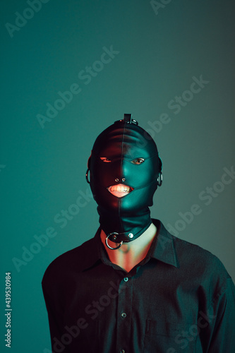 Young male wearing a gimp mask.
 photo